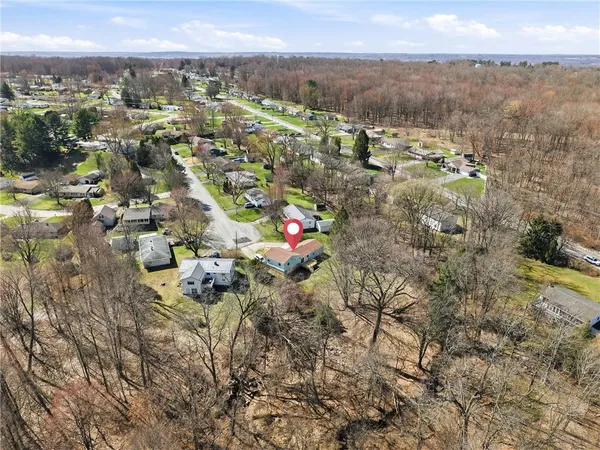 an aerial view of a house with yard