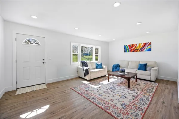 a living room with furniture and a rug