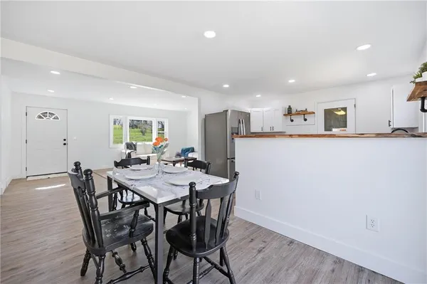 a view of a dining room with furniture and wooden floor