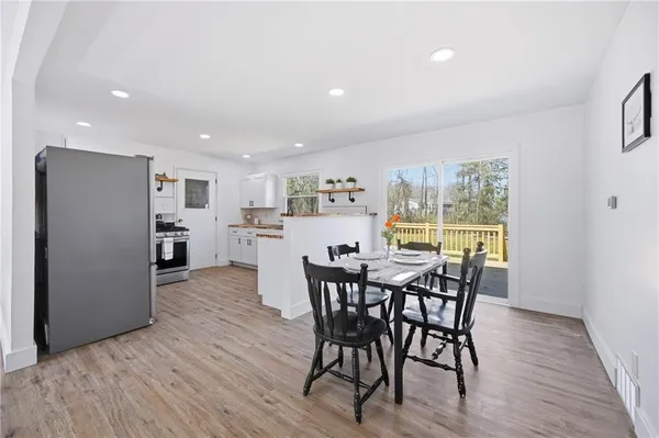 a view of a dining room with furniture and wooden floor