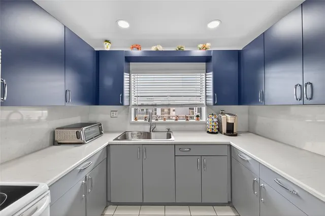 a kitchen with a sink cabinets and window
