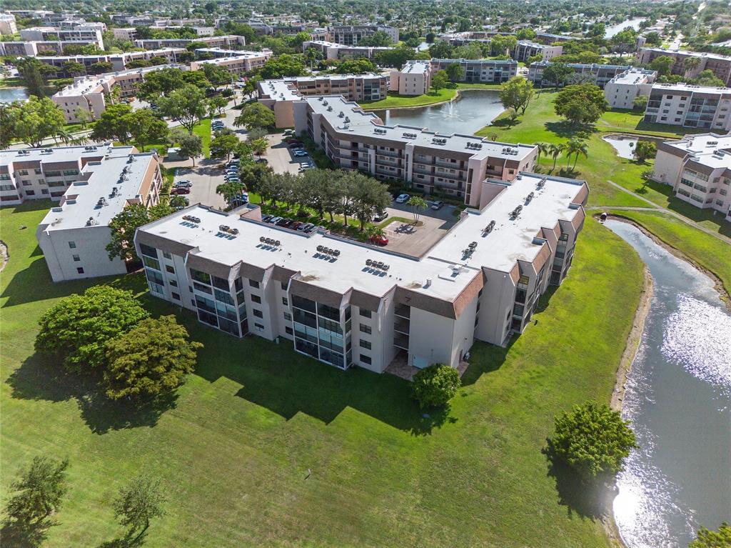 10145 Sunrise Lakes Boulevard, Unit 406 Sunrise, FL 33322 - Photo 24 of 37 a view of a house with a yard and lake view