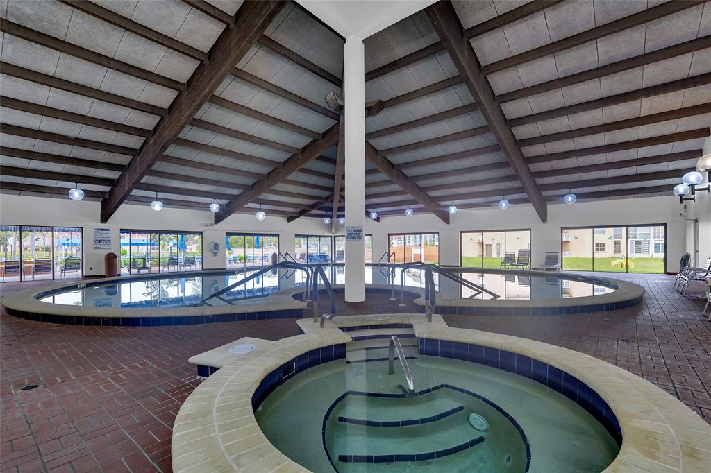 10145 Sunrise Lakes Boulevard, Unit 406 Sunrise, FL 33322 - Photo 27 of 37 a dining room with lots of wooden furniture