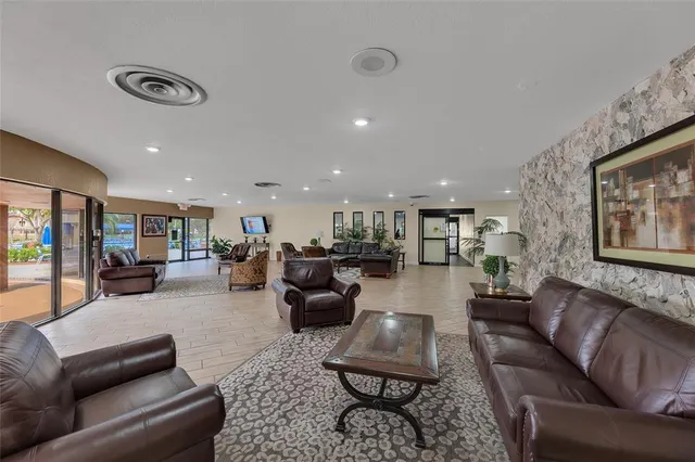 a living room with furniture kitchen view and a couch