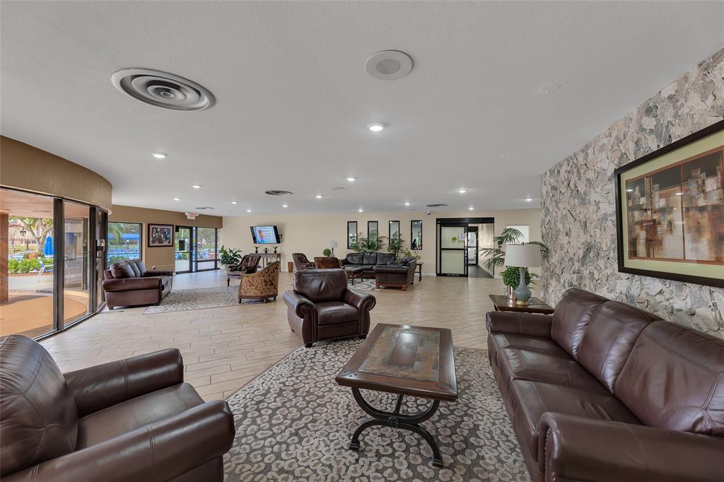 10145 Sunrise Lakes Boulevard, Unit 406 Sunrise, FL 33322 - Photo 31 of 37 a living room with furniture kitchen view and a couch