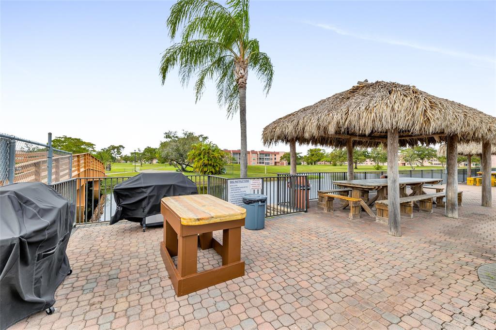 10145 Sunrise Lakes Boulevard, Unit 406 Sunrise, FL 33322 - Photo 34 of 37 a view of a backyard with sitting area and furniture