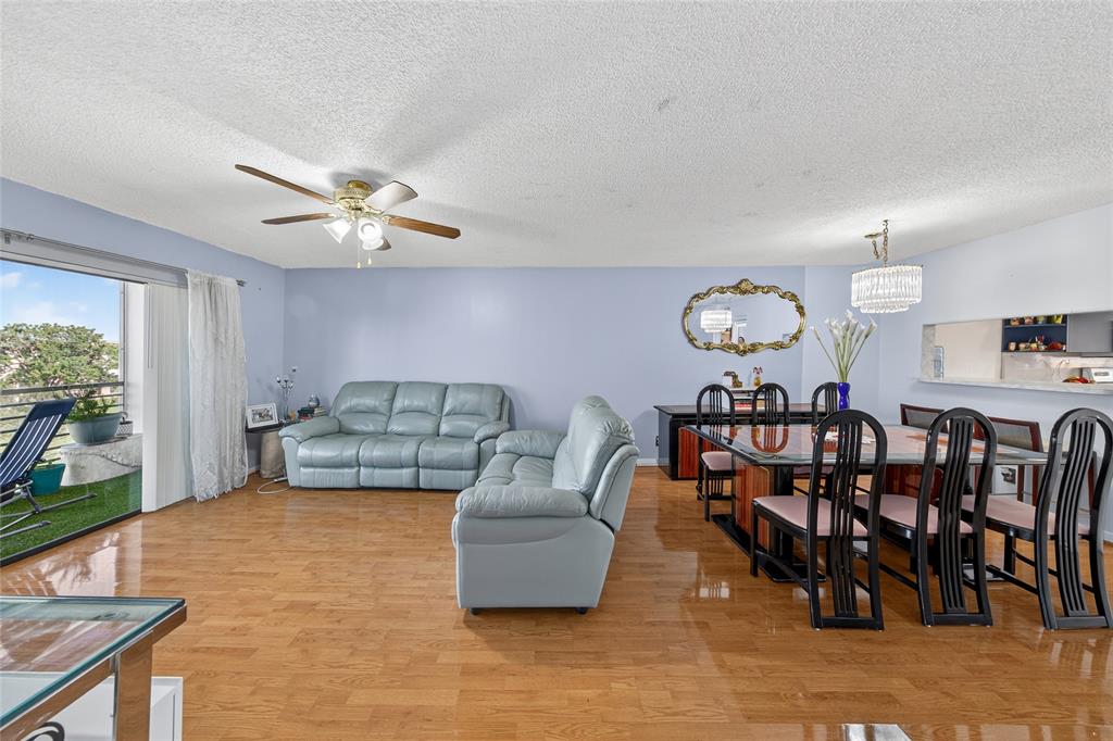 10145 Sunrise Lakes Boulevard, Unit 406 Sunrise, FL 33322 - Photo 5 of 37 a living room with furniture kitchen view and a large window