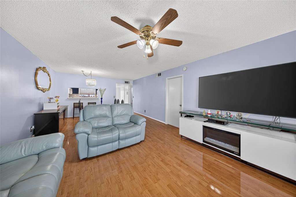10145 Sunrise Lakes Boulevard, Unit 406 Sunrise, FL 33322 - Photo 7 of 37 a living room with furniture and a flat screen tv