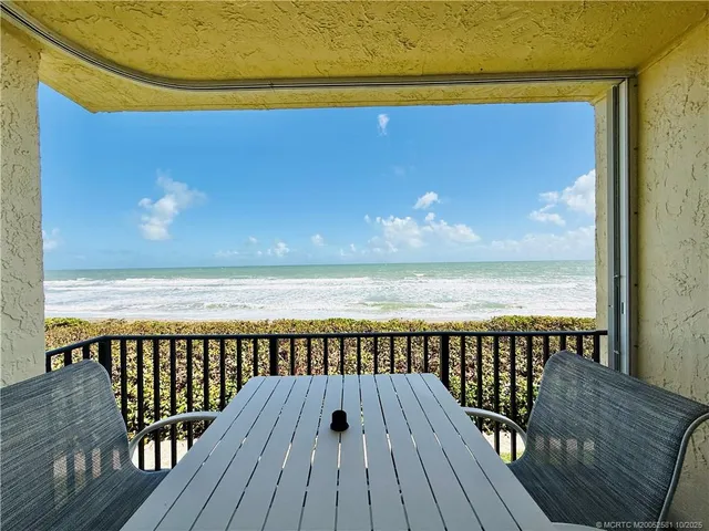 a view of a balcony with an ocean view