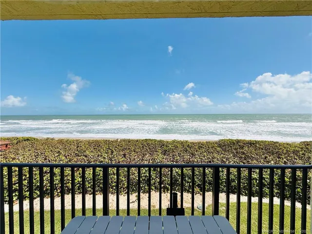 a view of a balcony with wooden floor and furniture