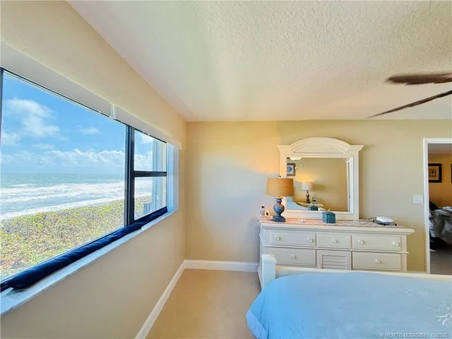 a en suite bathroom with a granite countertop sink and a mirror