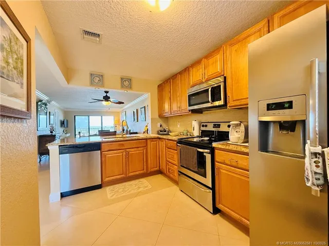 a kitchen with stainless steel appliances granite countertop a sink and cabinets