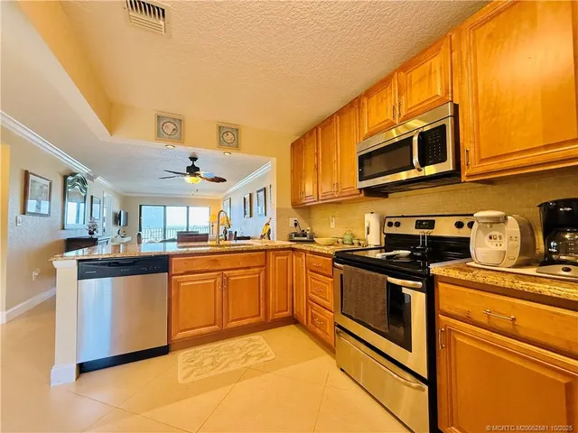 a kitchen with stainless steel appliances granite countertop a stove and a sink