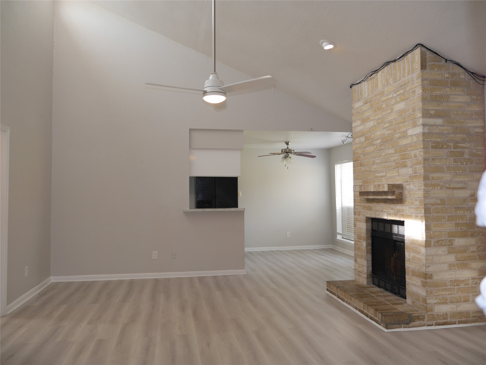 7410 Canasta Lane Houston, TX 77083 - Photo 17 of 33 an empty room with windows and fireplace