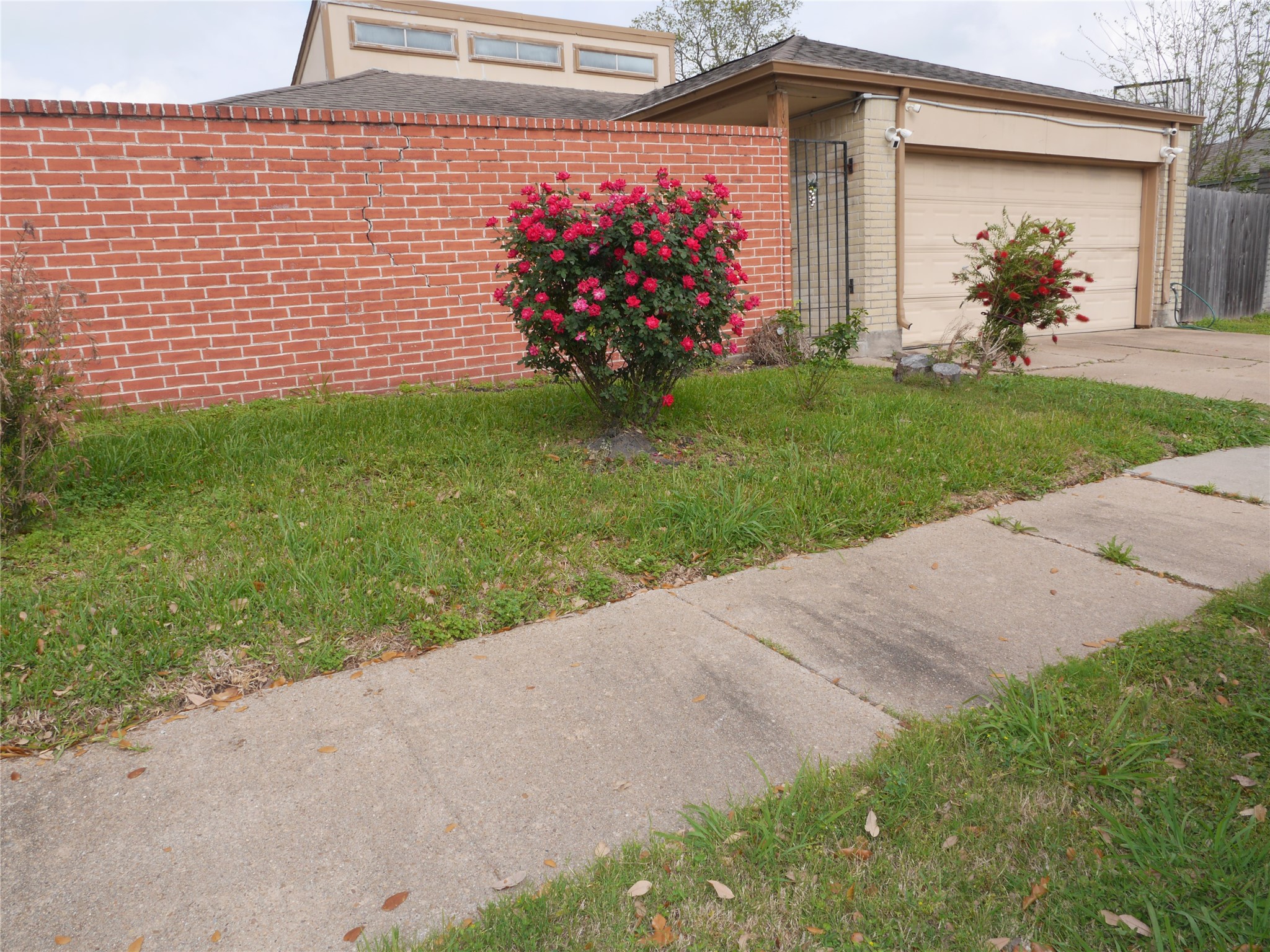 7410 Canasta Lane Houston, TX 77083 - Photo 2 of 33 a front view of a house with a yard and a garage