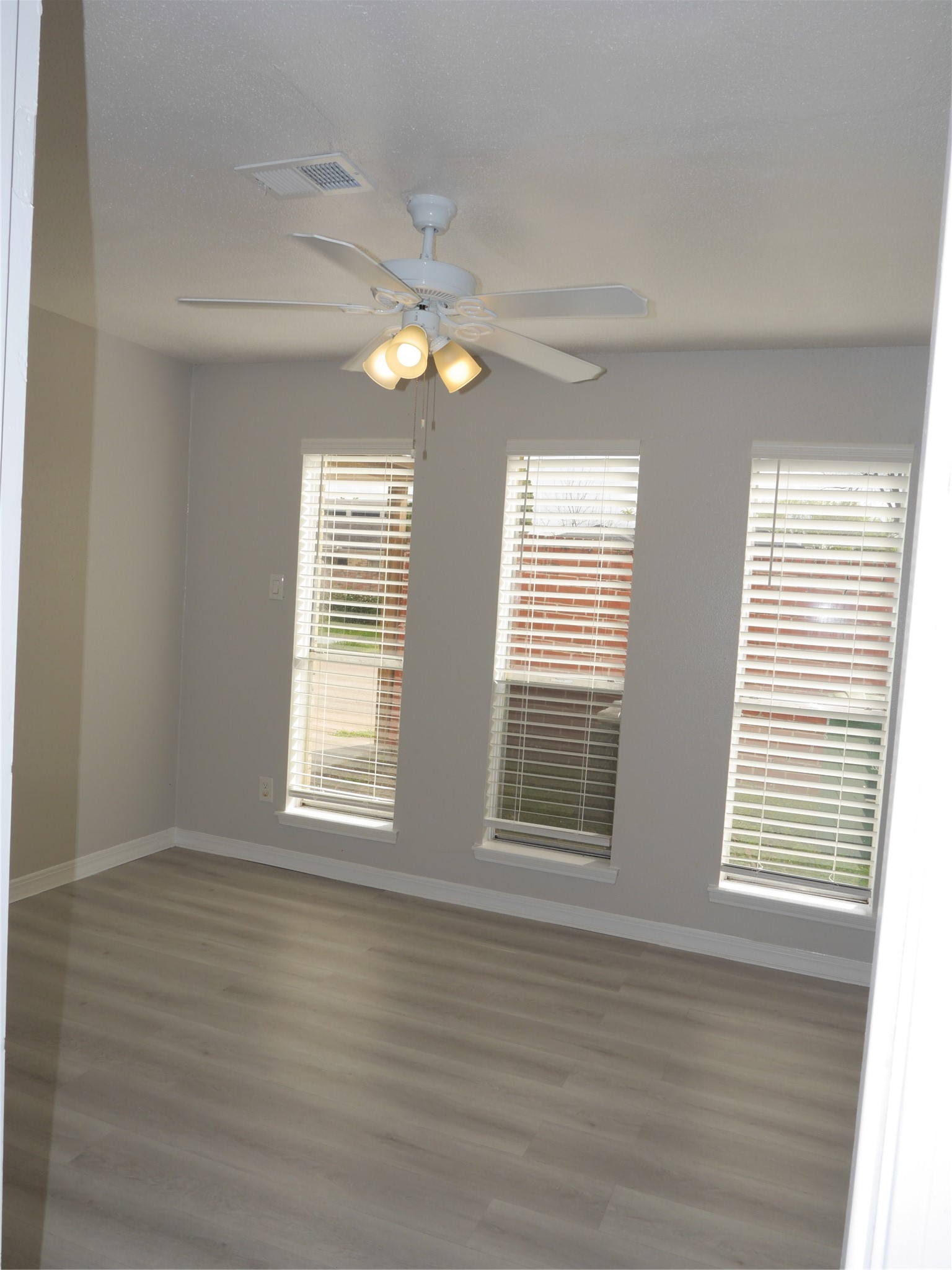 7410 Canasta Lane Houston, TX 77083 - Photo 5 of 33 a view of an empty room with wooden floor and a window