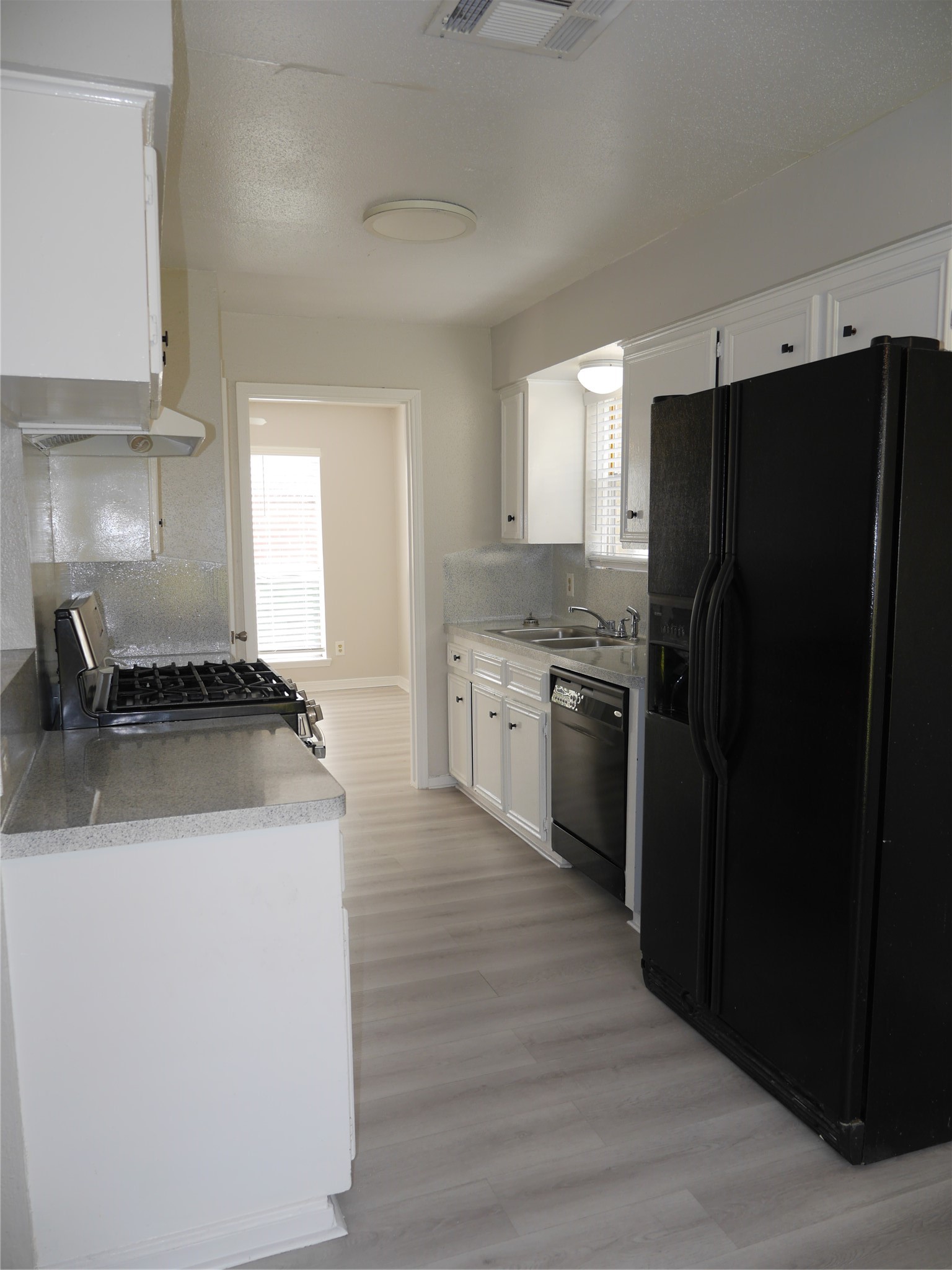 7410 Canasta Lane Houston, TX 77083 - Photo 6 of 33 a kitchen with a sink a stove and refrigerator