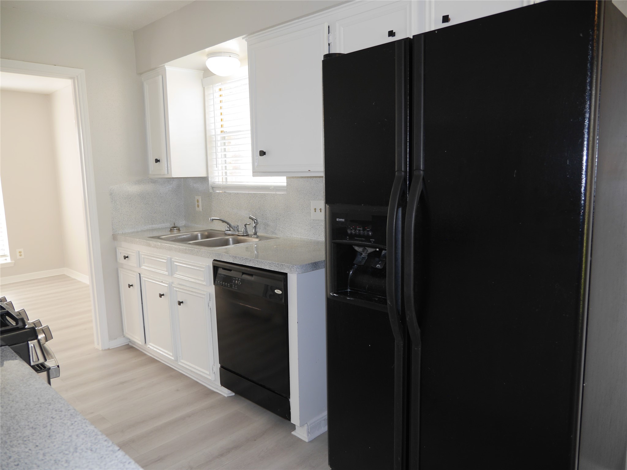 7410 Canasta Lane Houston, TX 77083 - Photo 8 of 33 a kitchen with a refrigerator and a sink