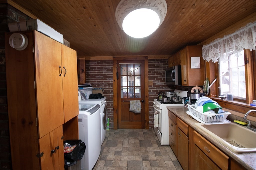76 Ashfield Road Buckland, MA 01370 - Photo 12 of 32 a kitchen with a sink appliances cabinets and a large window