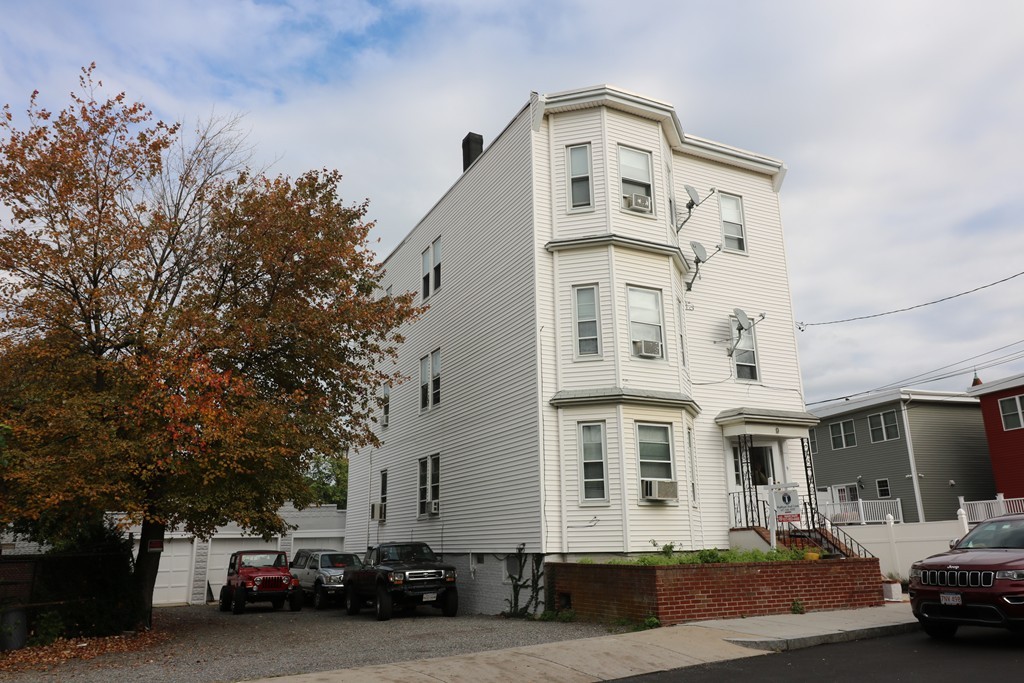 9 Whitby Street Boston, MA 02128 - Photo 2 of 15 a front view of a building with cars parked