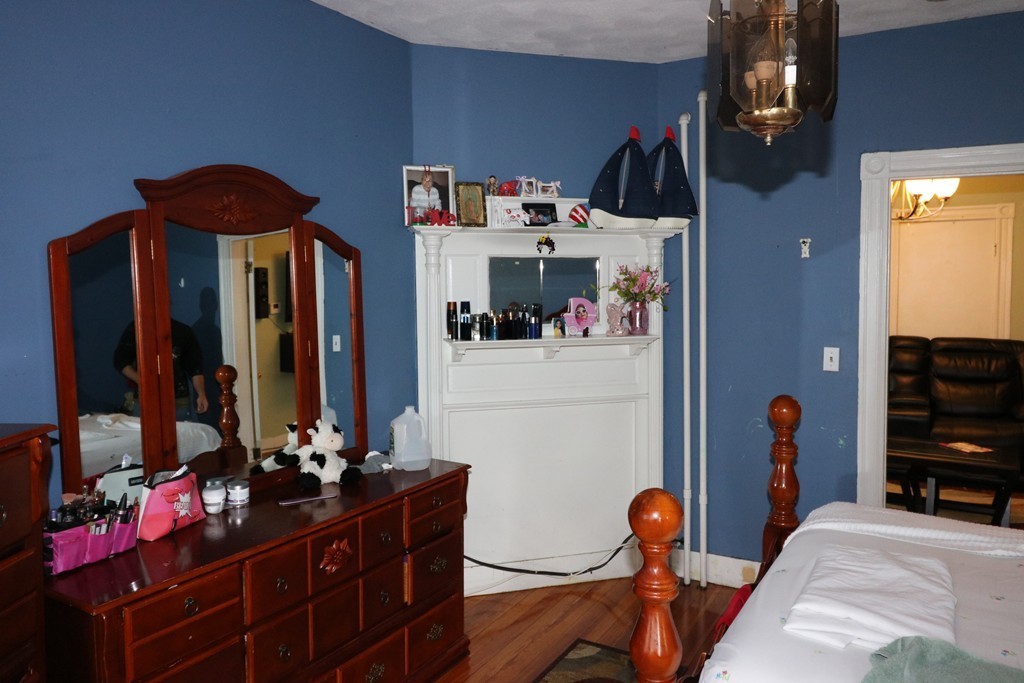 9 Whitby Street Boston, MA 02128 - Photo 8 of 15 a bedroom with bed and a mirror