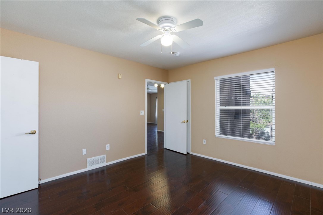 6650 West Warm Springs Road, Unit 2027 Las Vegas, NV 89118 - Photo 21 of 29 This inviting bedroom features rich hardwood flooring and ample natural light, creating a comfortable living space.