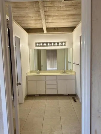 a bathroom with a mirror a bathtub and a sink