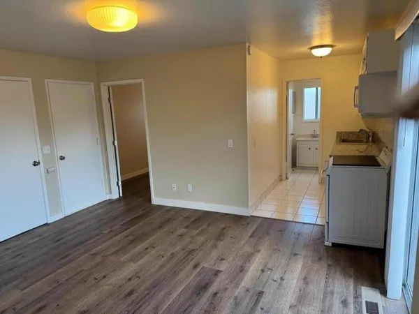 a view of a kitchen cabinets and wooden floor