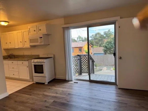 a kitchen with wooden cabinets and a stove