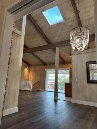 a view of an entryway with wooden floor