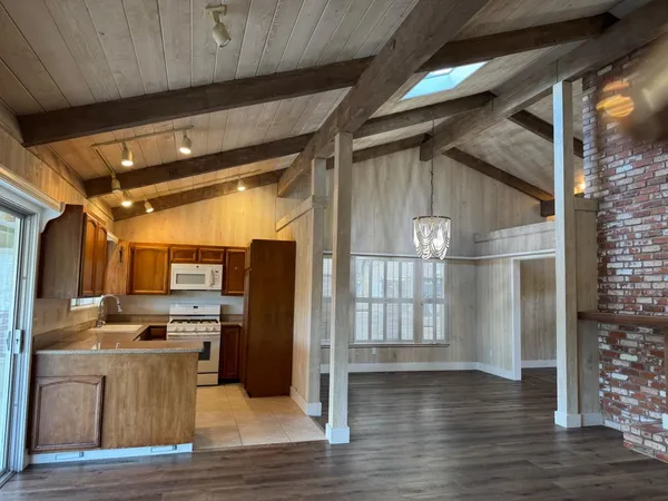 a view of a refrigerator in kitchen and wooden floor