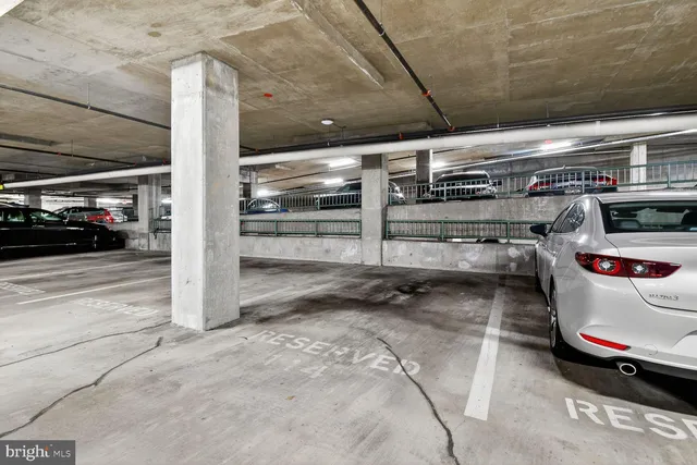 a view of parking garage with cars