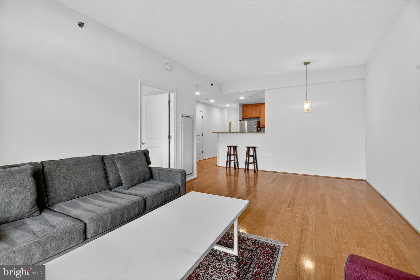 11700 Old Georgetown Road, Unit 714 Rockville, MD 20852 - Photo 8 of 21 a living room with furniture and a wooden floor