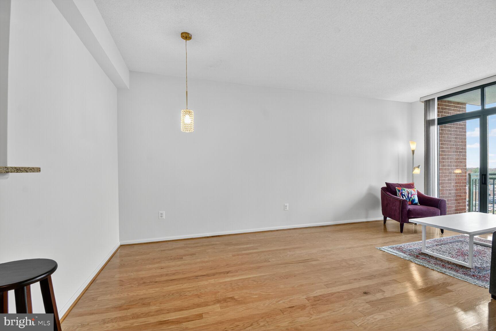 11700 Old Georgetown Road, Unit 714 Rockville, MD 20852 - Photo 10 of 21 a view of empty room with wooden floor and fan