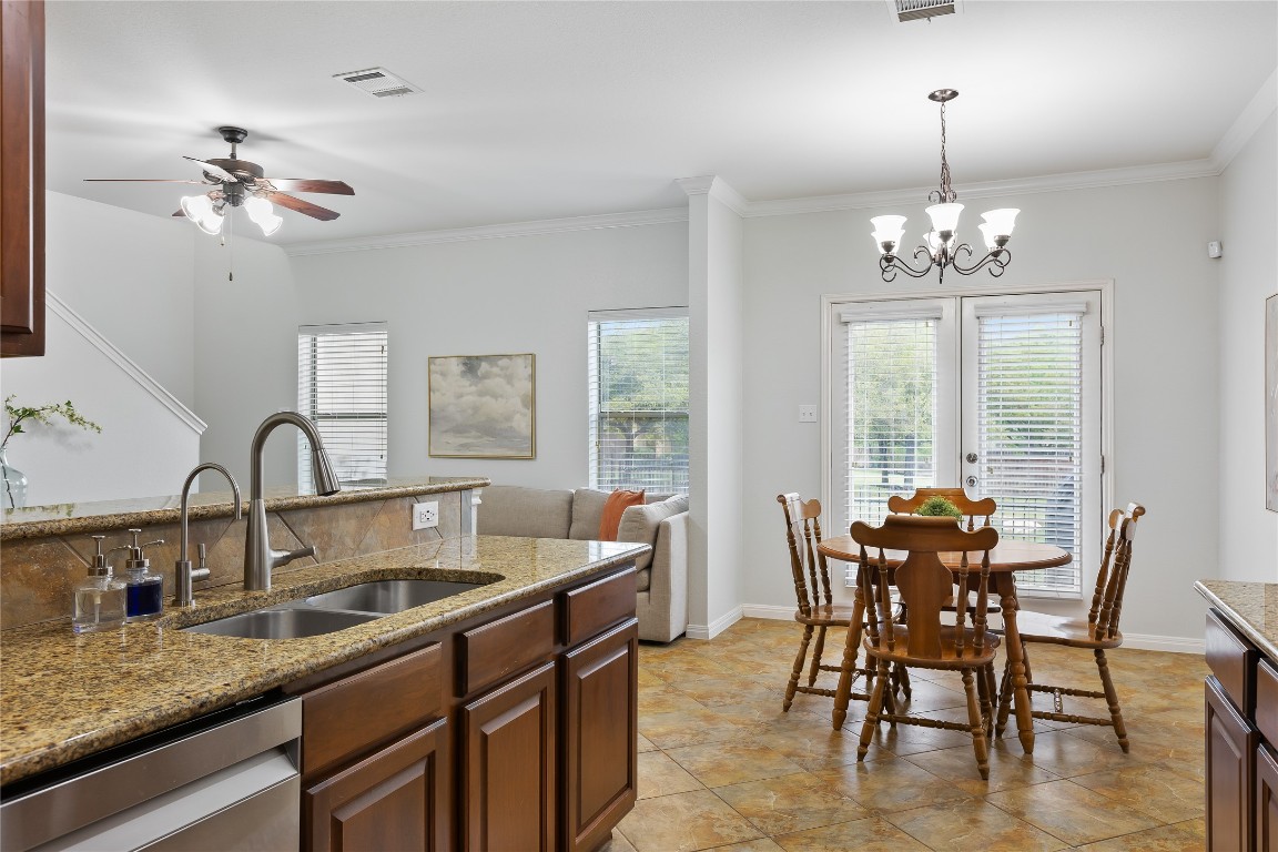 11237 Lost Maples Trail Austin, TX 78748 - Photo 11 of 35 a dining room with furniture a chandelier and window