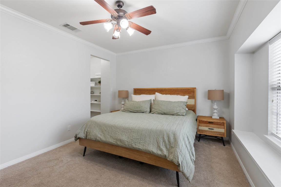 11237 Lost Maples Trail Austin, TX 78748 - Photo 18 of 35 a bedroom with a bed and a chandelier