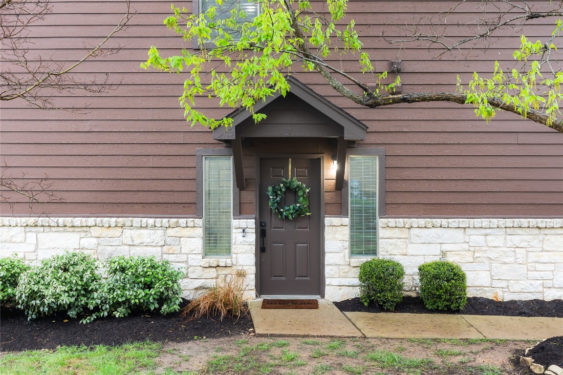 11237 Lost Maples Trail Austin, TX 78748 - Photo 4 of 35 a front view of a house with a yard and potted plants