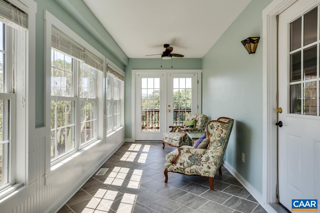 5289 Free Union Road Free Union, VA 22940 - Photo 39 of 63 a living room with furniture and a floor to ceiling window
