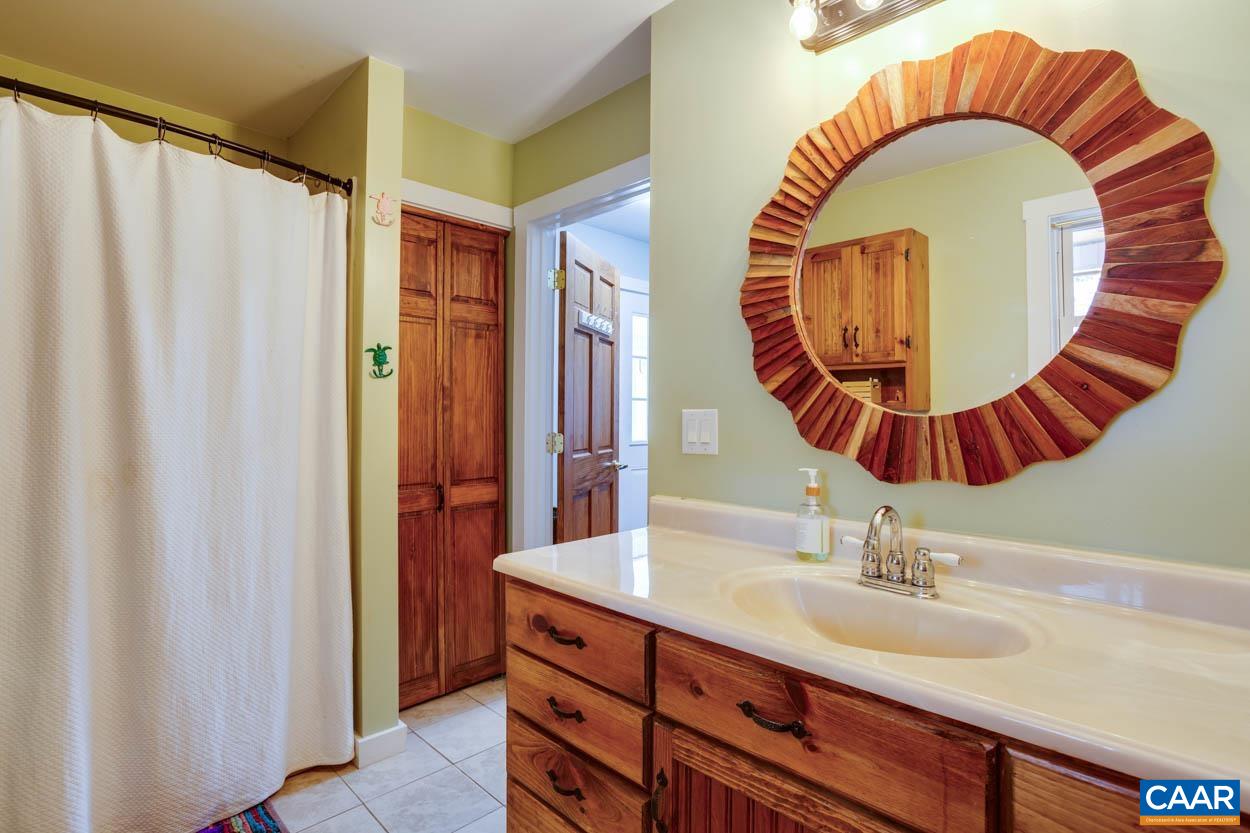 5289 Free Union Road Free Union, VA 22940 - Photo 42 of 63 a bathroom with a sink and a mirror