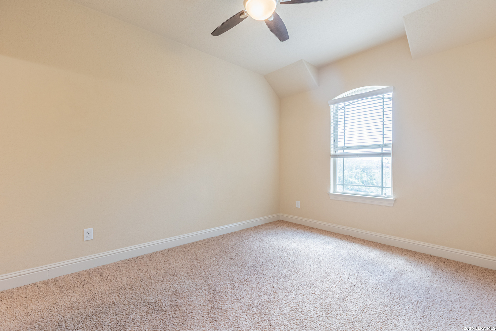8103 Mystic Chase Boerne, TX 78015 - Photo 36 of 49 an empty room with a window and a ceiling fan