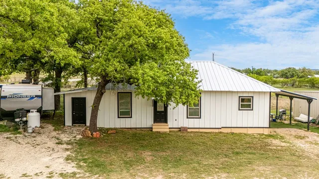 a view of a house with a backyard