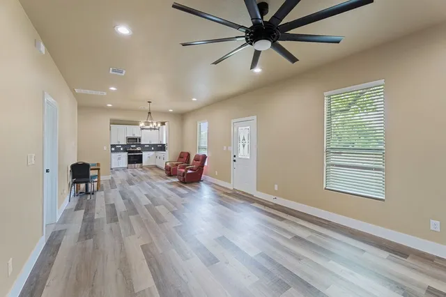a living room with furniture and a wooden floor