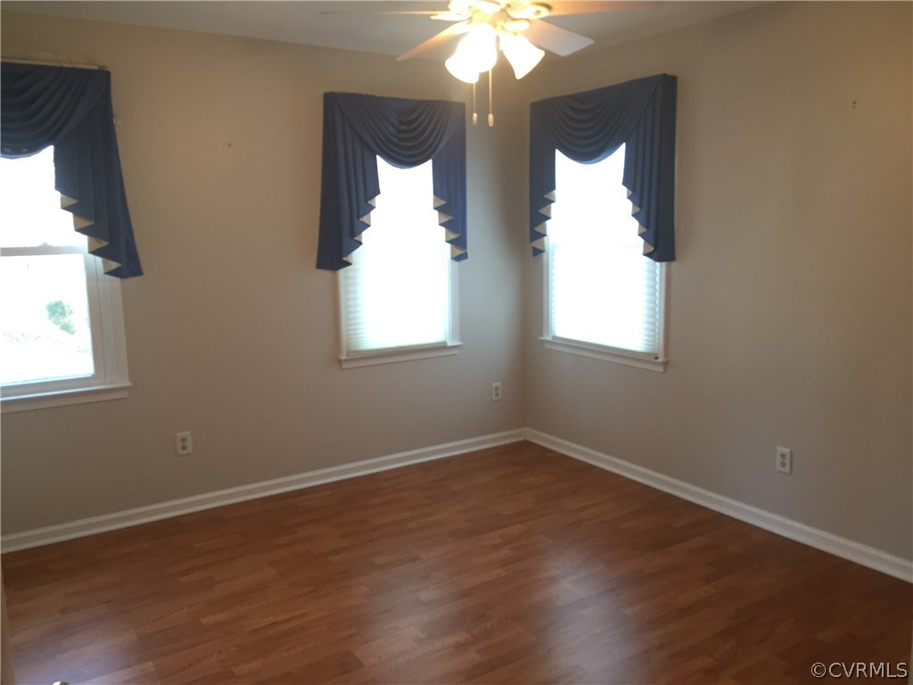 3807 Doe Run Road Hopewell, VA 23860 - Photo 19 of 29 an empty room with wooden floor and windows