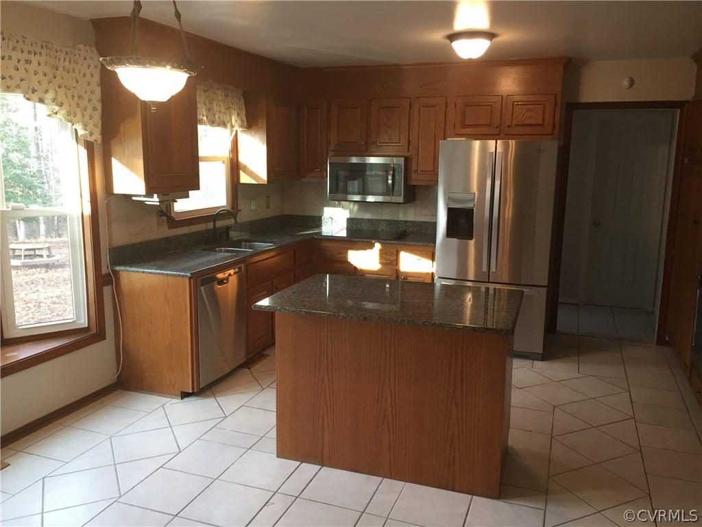3807 Doe Run Road Hopewell, VA 23860 - Photo 3 of 29 a kitchen with granite countertop a stove a refrigerator and a sink