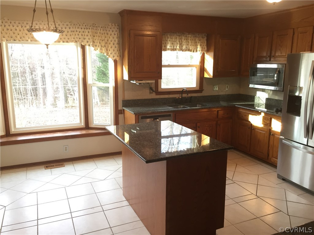 3807 Doe Run Road Hopewell, VA 23860 - Photo 4 of 29 a kitchen with granite countertop a stove a sink and a refrigerator
