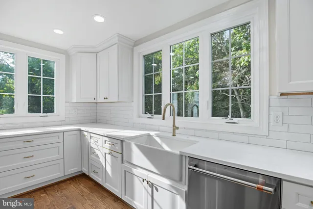 a kitchen with a sink and large window