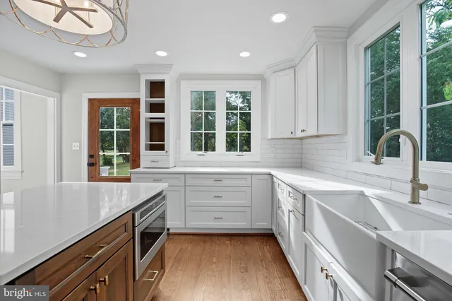 a kitchen with a sink stove and cabinets