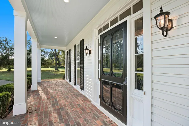 a view of a porch with wooden floor and iron stairs