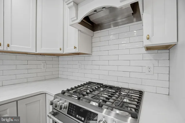 a kitchen with granite countertop a stove and a sink