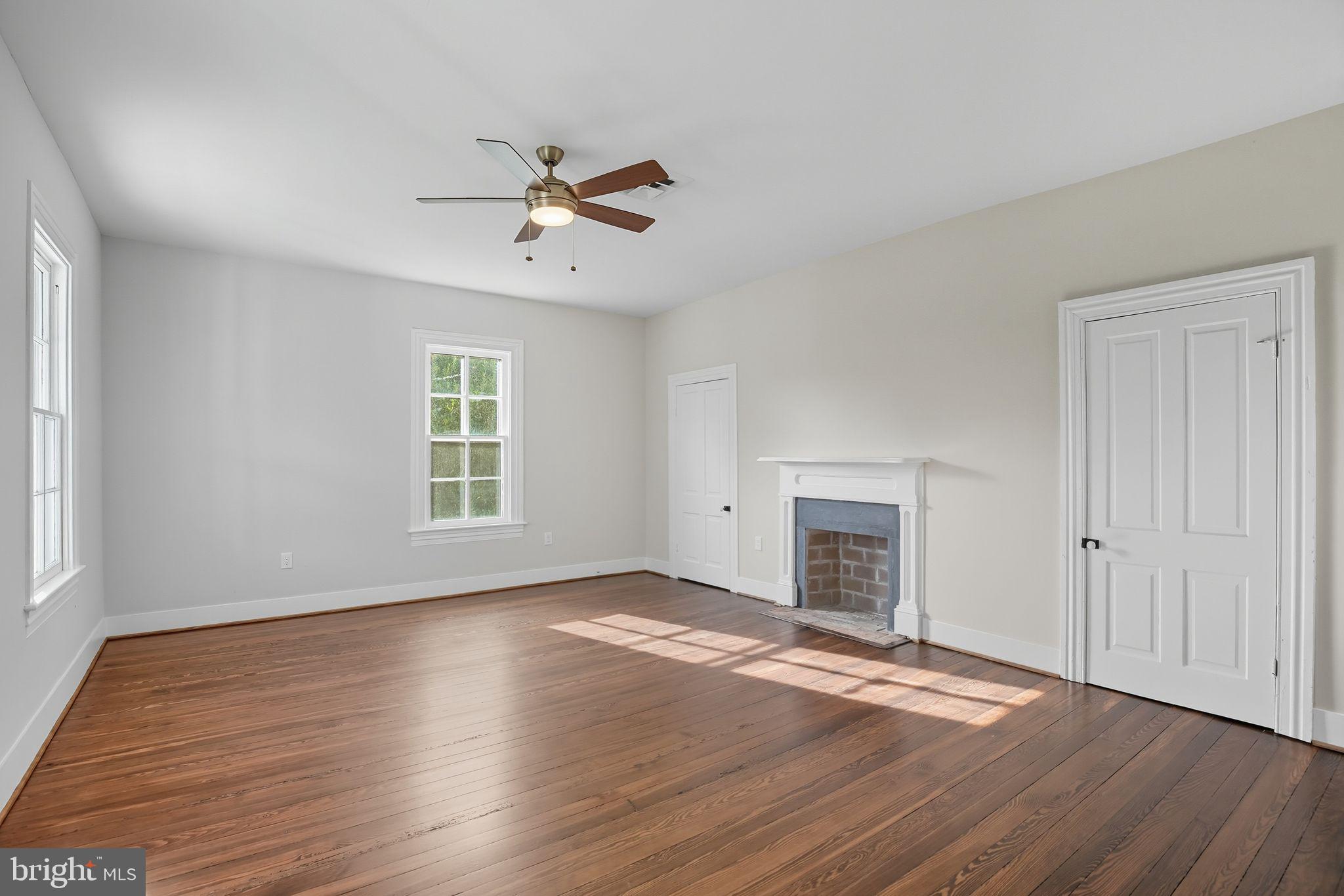 5965 Acorn Spring Place La Plata, MD 20646 - Photo 29 of 54 an empty room with wooden floor fireplace and windows